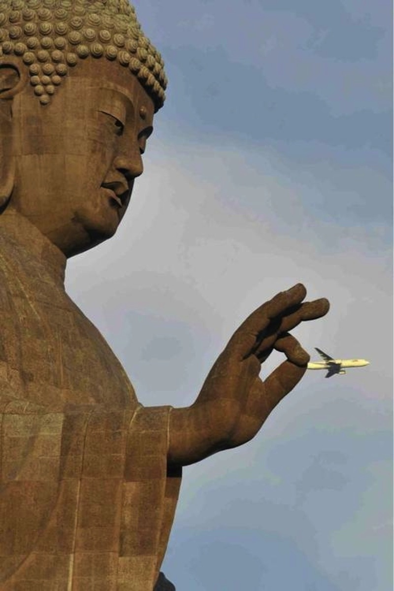 a statue of buddha captures a commercial airliner by its tail